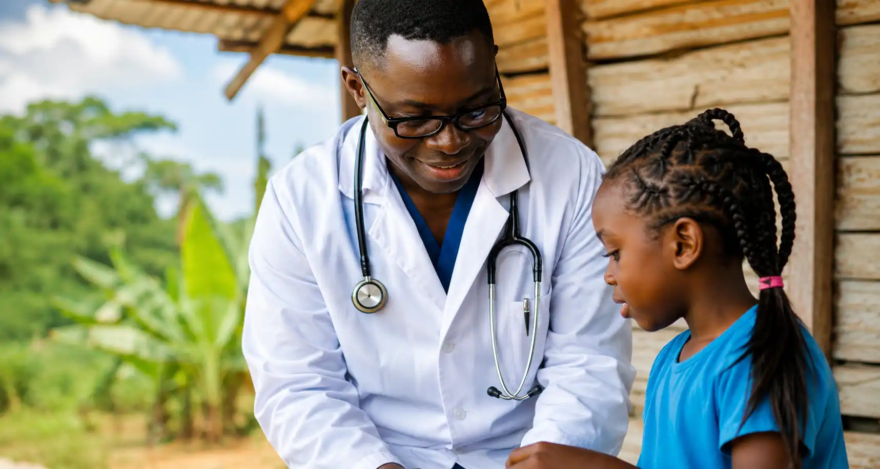 A doctor attending to a child in the community
